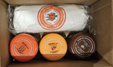 Three containers and a wrapped item in a cardboard box with visible branding.