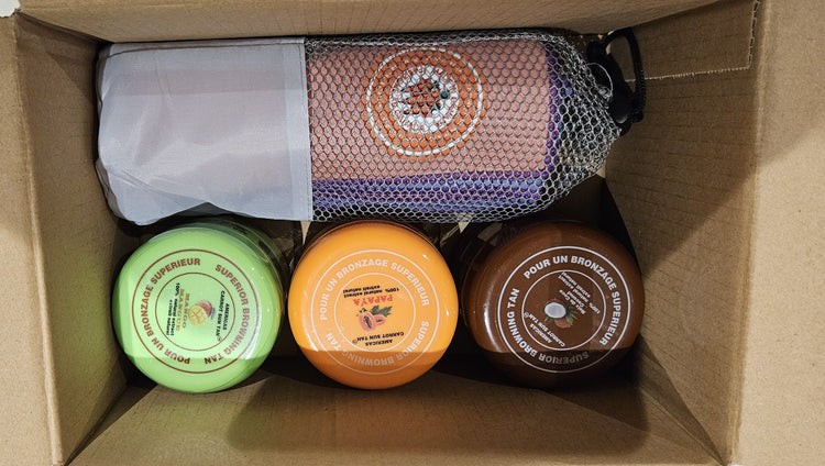 Three jars with labels and a mesh bag inside a cardboard box.