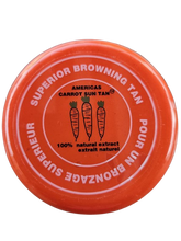 A container of Americas Carrot Sun Tan tanning cream with a red lid, featuring product information on the label.