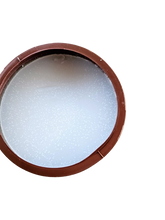 An opened container of Americas coconut Sun Tan tanning cream with a brown lid, featuring product information on the label.