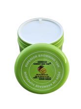 A container of Americas Carrot Sun Tan tanning cream with a green lid, featuring product information on the label.